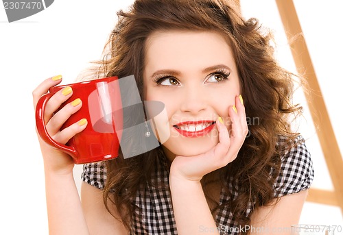 Image of young attractive woman in the kitchen