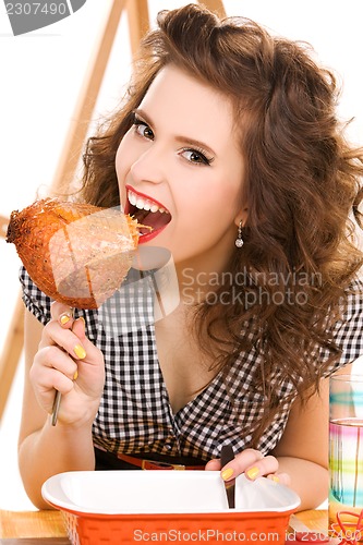 Image of young attractive woman in the kitchen
