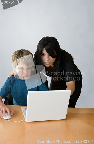 Image of Adult assisting child on computer