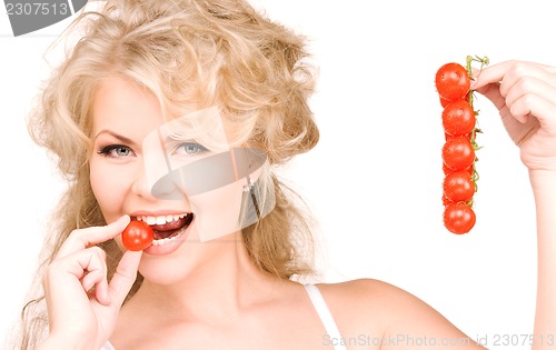 Image of young beautiful woman with ripe tomatoes