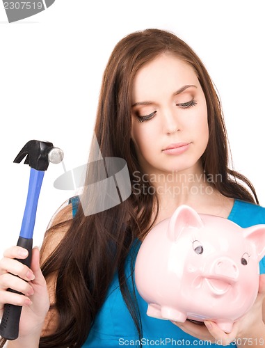 Image of teenage girl with piggy bank and hammer