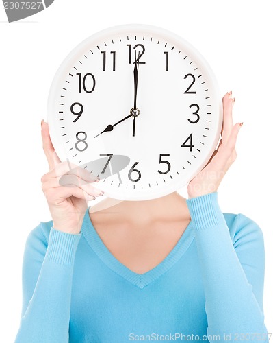 Image of woman with big clock covering face