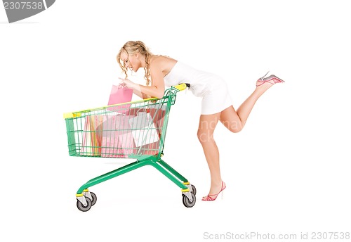 Image of woman with shopping cart over white