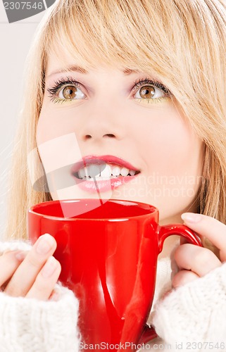 Image of happy teenage girl with red mug