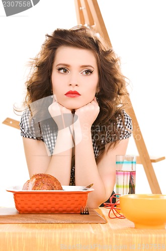 Image of young attractive woman in the kitchen