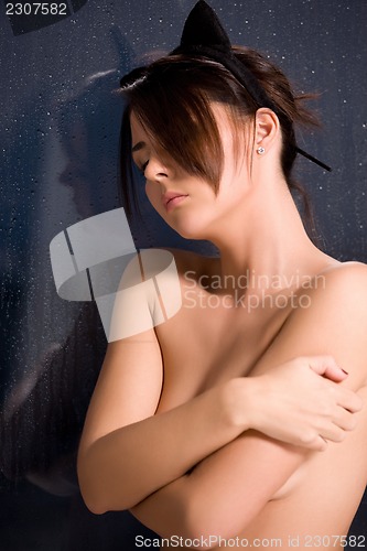 Image of woman with cat ears at the rainy window