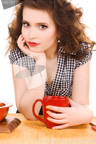 Image of young attractive woman in the kitchen