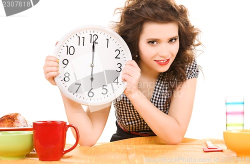 Image of young attractive woman in the kitchen