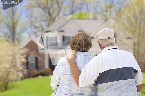 Image of Happy Senior Couple Looking at Front of House