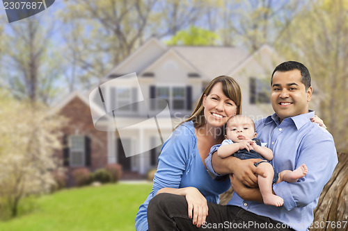 Image of Happy Mixed Race Couple in Front of House