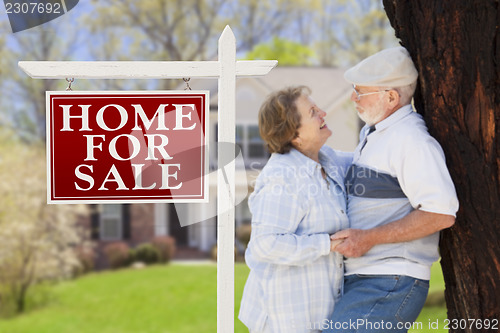 Image of Happy Senior Couple Front of For Sale Sign and House