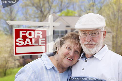 Image of Happy Senior Couple Front of For Sale Sign and House