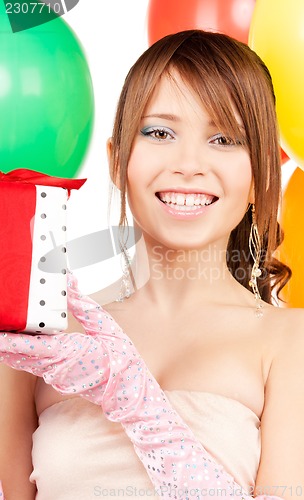 Image of party girl with balloons and gift box