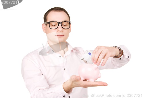 Image of businessman with piggy bank and money