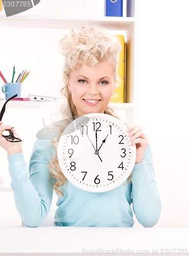 Image of woman holding big clock