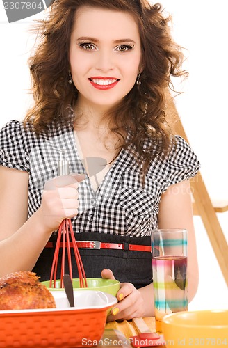 Image of young attractive woman in the kitchen