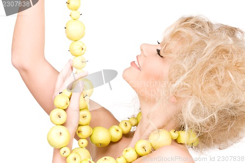 Image of happy woman with green apples