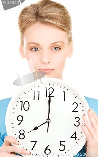 Image of woman holding big clock