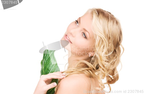 Image of woman with green leaf