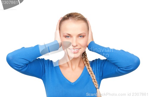 Image of smiling woman with hands over ears