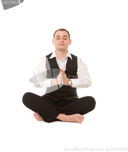 Image of businessman sitting in lotus pose