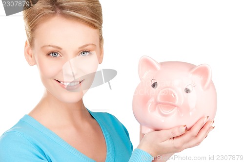 Image of lovely woman with piggy bank