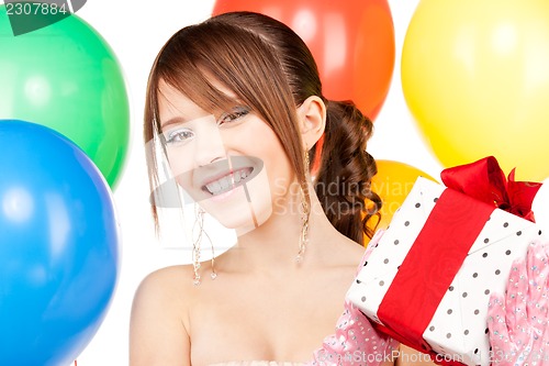 Image of party girl with balloons and gift box