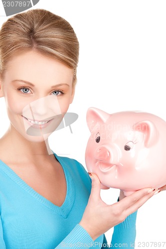 Image of lovely woman with piggy bank