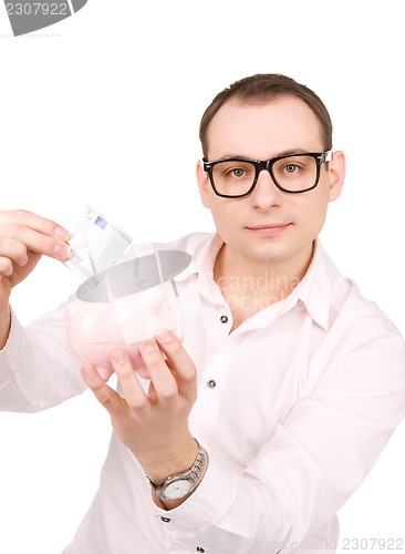 Image of businessman with piggy bank and money