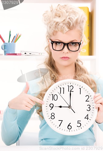 Image of woman holding big clock