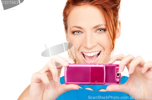 Image of happy woman using phone camera