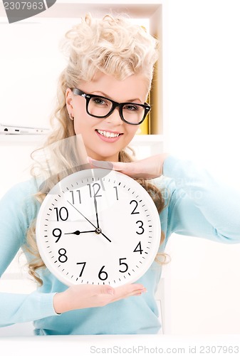 Image of woman holding big clock