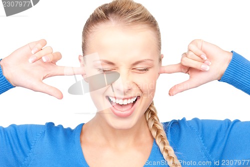 Image of smiling woman with fingers in ears