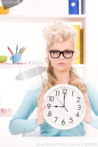 Image of woman holding big clock