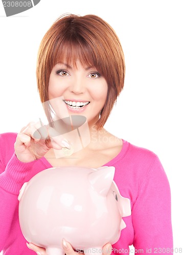 Image of lovely woman with piggy bank and money