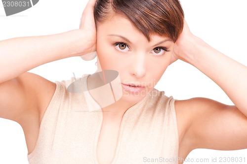 Image of unhappy woman with hands on ears