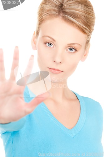 Image of young woman making stop gesture