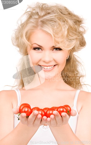 Image of young beautiful woman with ripe tomatoes