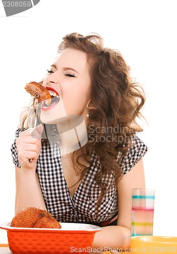 Image of young attractive woman in the kitchen