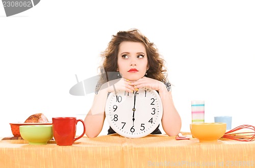 Image of young attractive woman in the kitchen