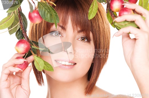 Image of happy woman with apple twig