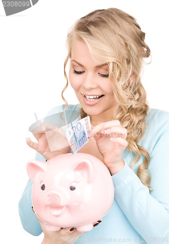 Image of lovely woman with piggy bank and money