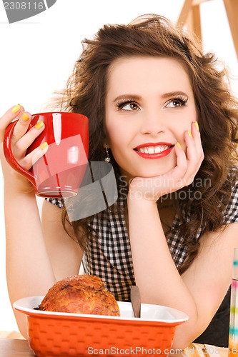 Image of young attractive woman in the kitchen