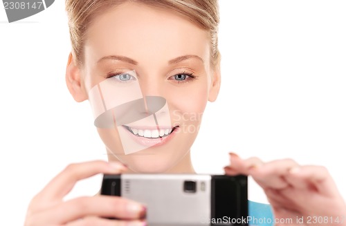 Image of happy woman using phone camera