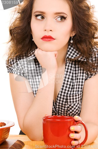 Image of young attractive woman in the kitchen