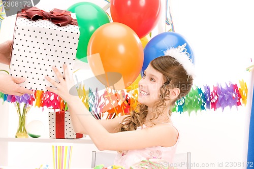 Image of party girl with balloons and gift box
