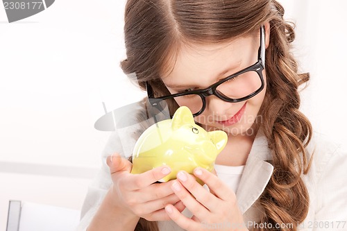 Image of little girl with piggy bank
