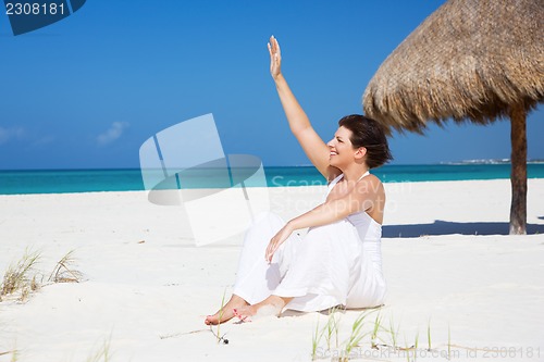 Image of happy woman on the beach