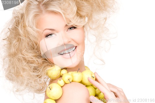 Image of happy woman with green apples