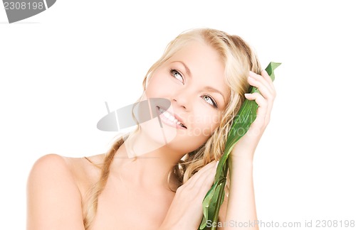 Image of woman with green leaf